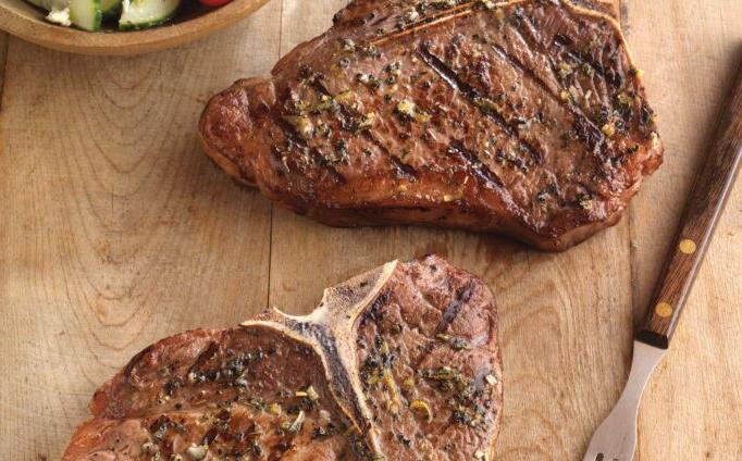 Greek-Seasoned T-Bone Steaks with Cucumber and Tomato Salad